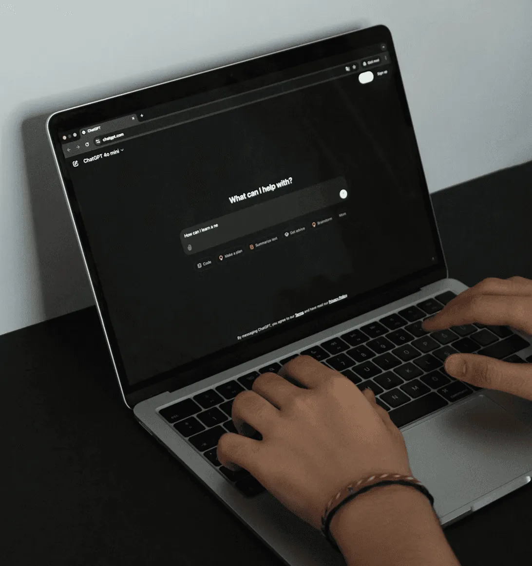 A white robotic hand holding a chip labeled AI